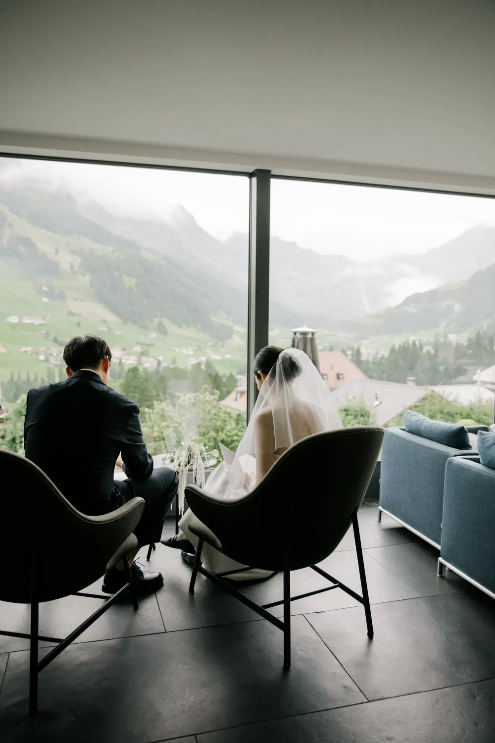 High-fashion getting-ready photos at The Cambrian Adelboden with misty mountain views, curated by ROOXI STUDIO.