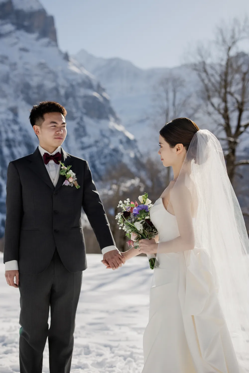 Romantic bride and groom portrait in the deep snow of the Swiss Alps