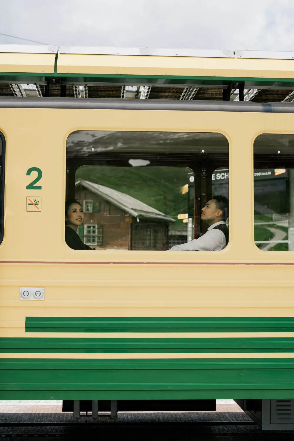 Cinematic black and white photography of a couple on the Jungfrau region mountain train in early summer.