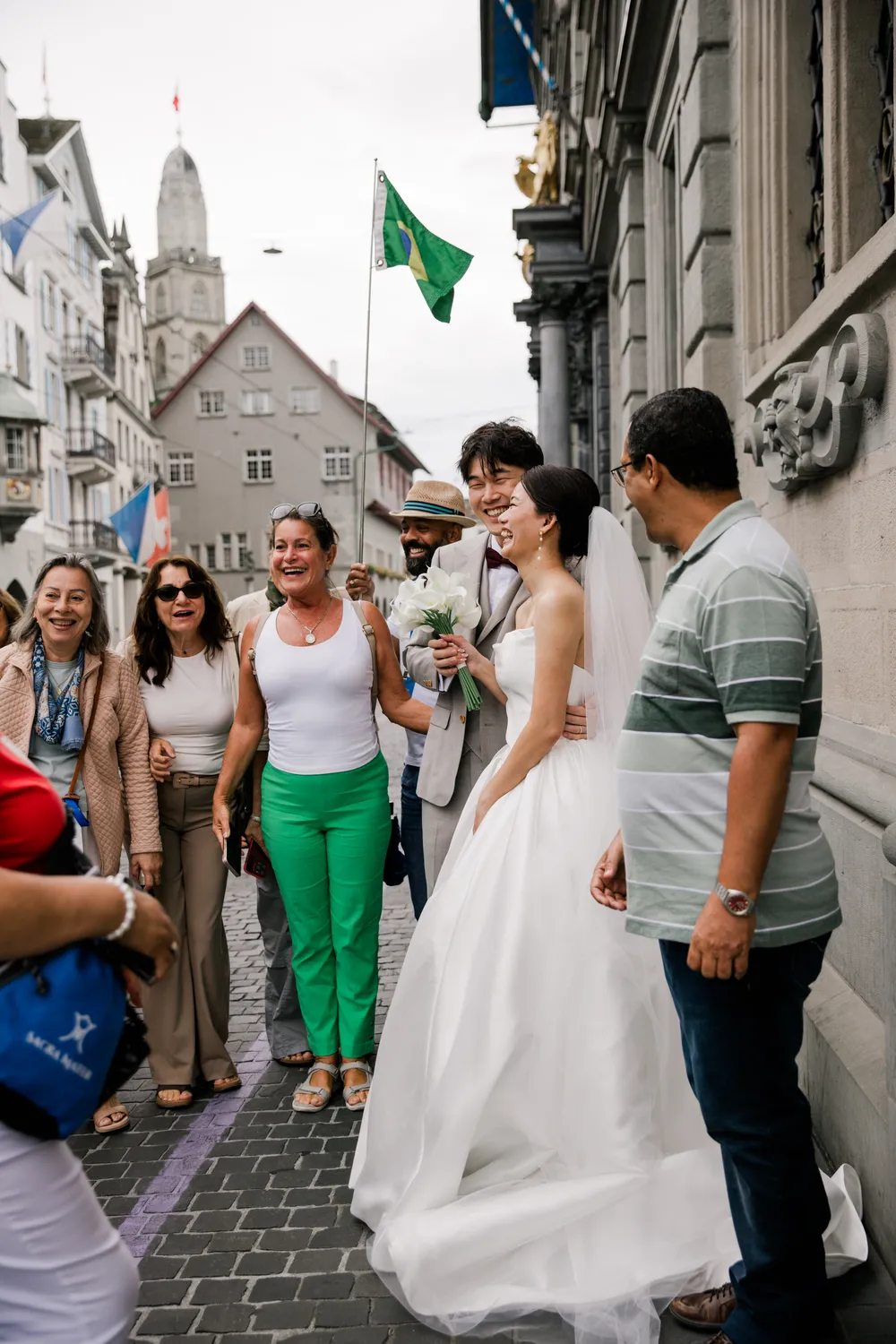 joyful, unscripted moment of a couple receiving blessings from a Brazilian tour group in the streets of Zurich.