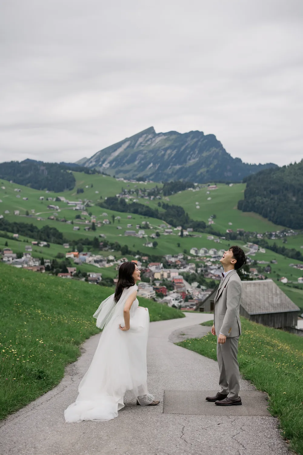 Romantic pre-wedding stroll on a winding path overlooking the village of Amden and Walensee in late summer.