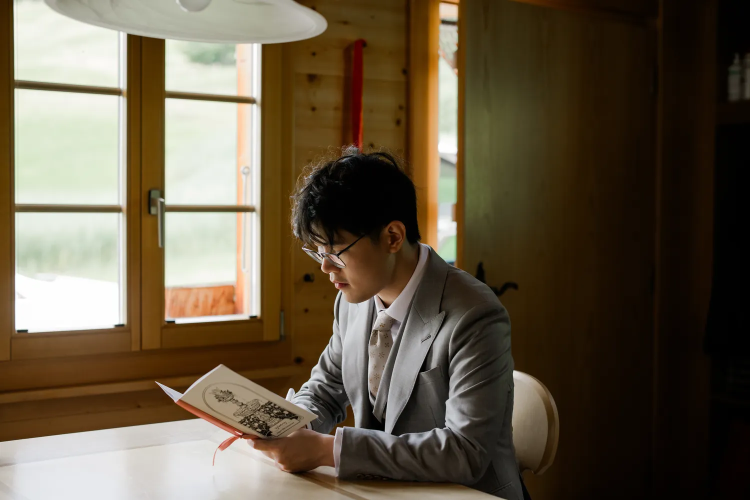 Documenting the groom privately writing his vows before their intimate **Swiss Alps elopement**.