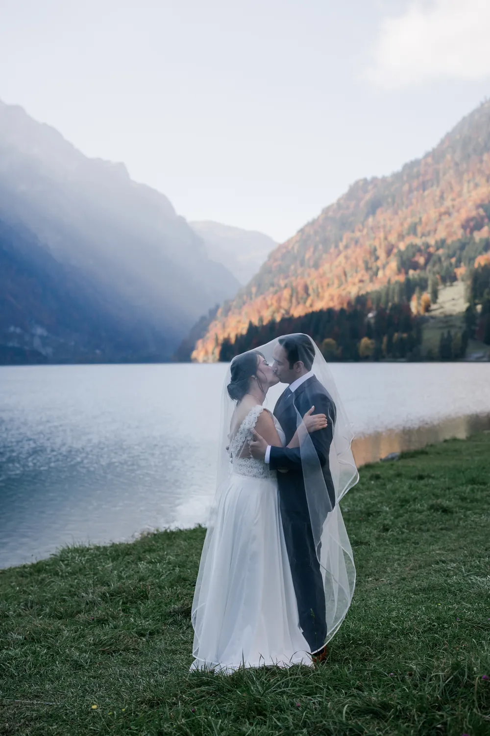 Bespoke pre-wedding session at Klontalersee featuring the dramatic mountain backdrop and autumn foliage.