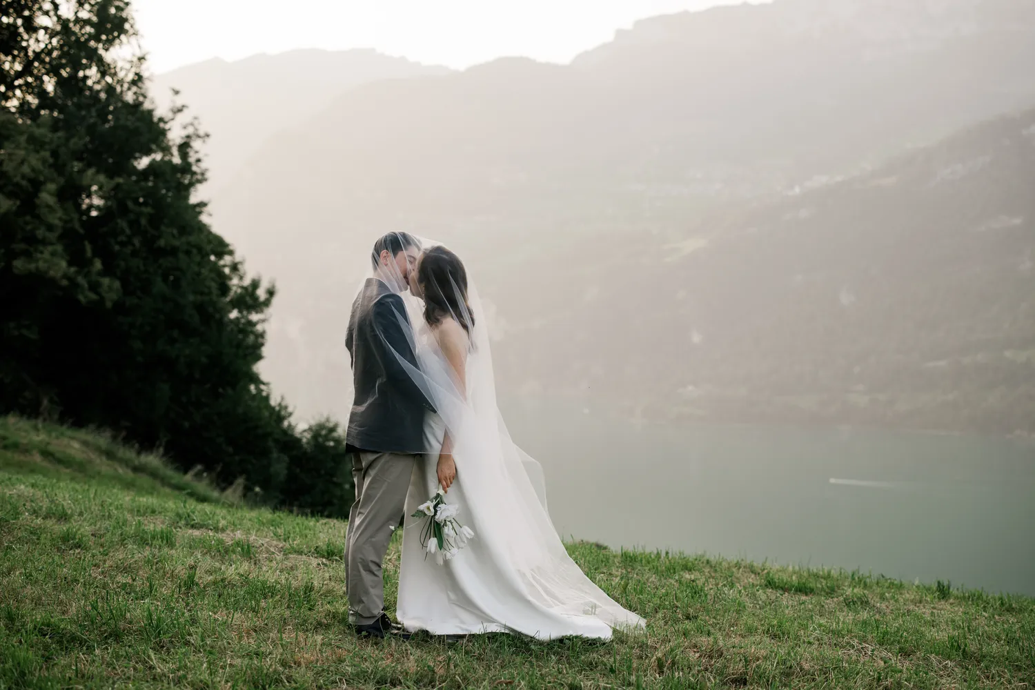 Romantic portrait of a Hong Kong couple amidst the sun-dappled alpine meadows overlooking Walensee in **August**.