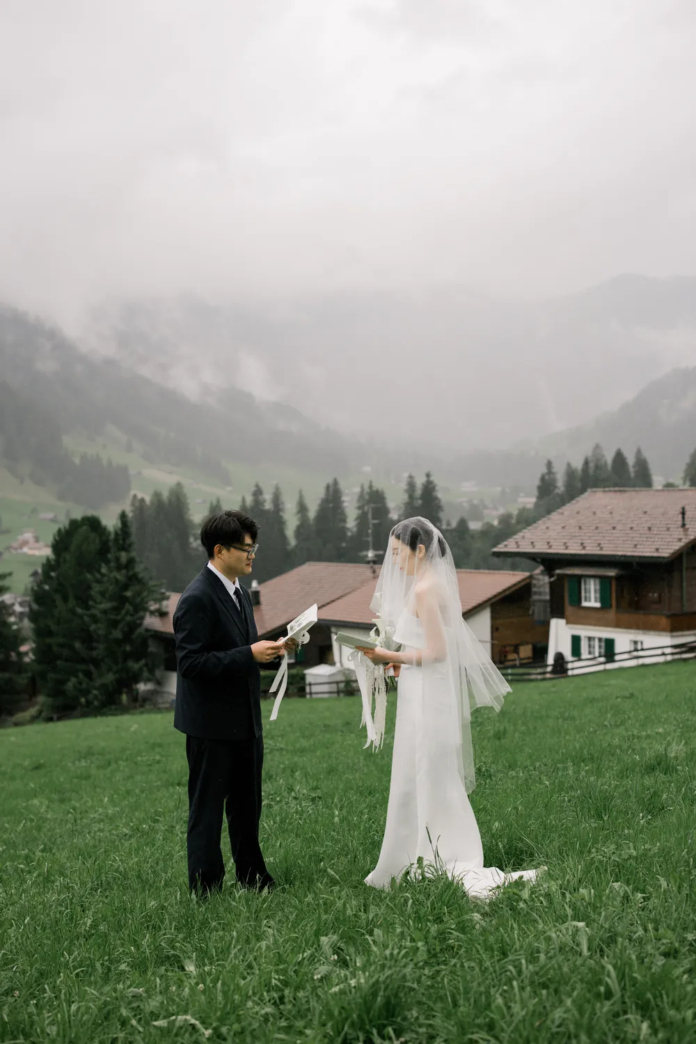 Intimate rainy wedding ceremony with snow-capped mountain views in Adelboden