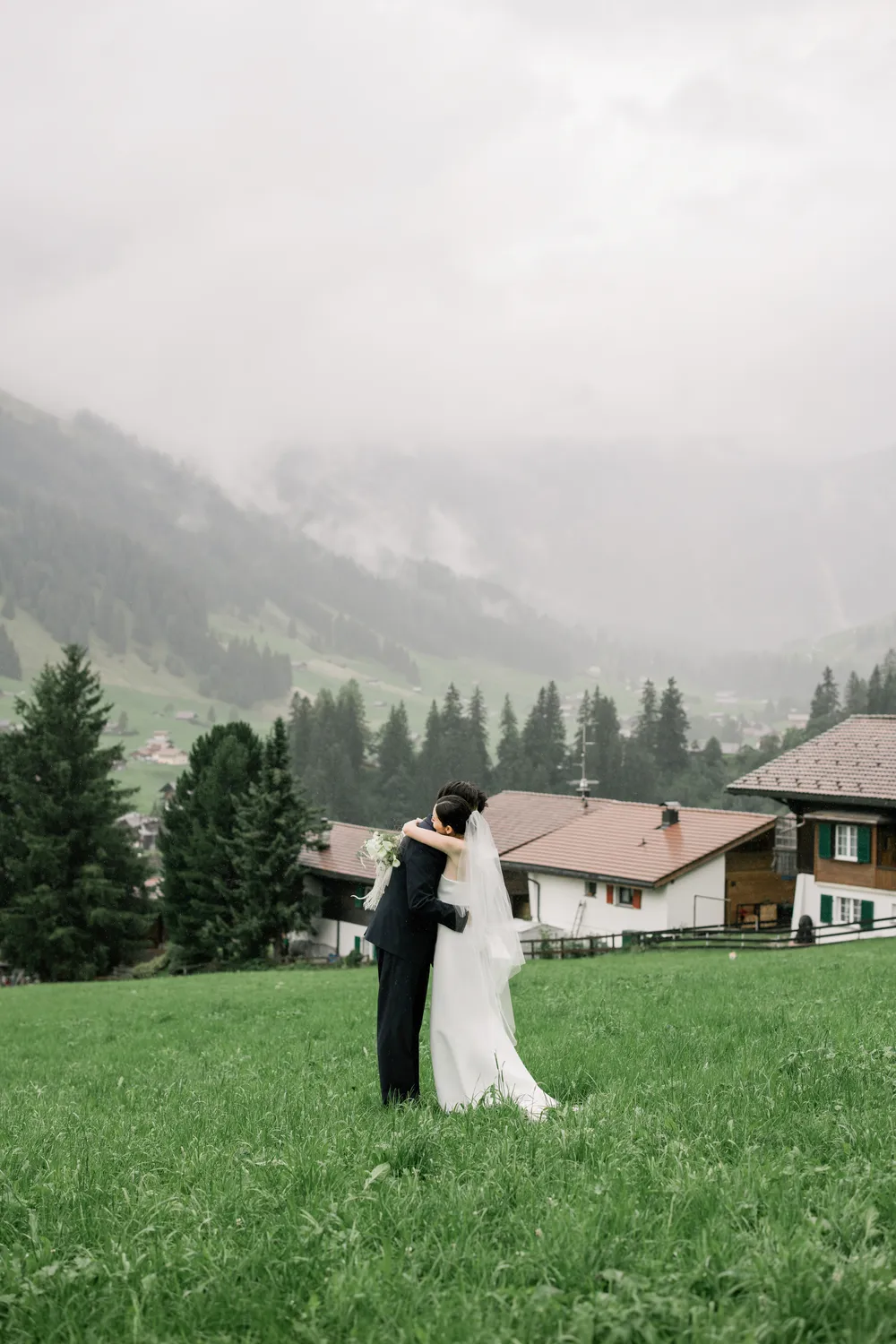 Intimate rainy wedding ceremony with snow-capped mountain views in Adelboden