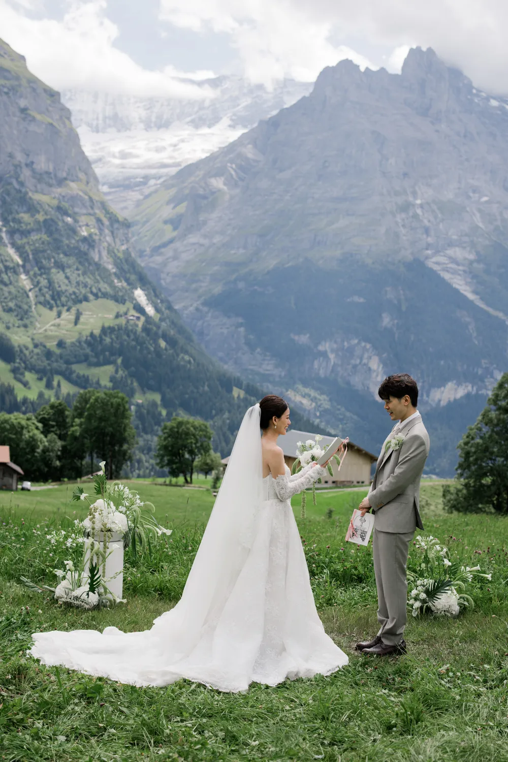 Soulful **elopement photography** of a private ceremony amidst the wild green meadows of Grindelwald.