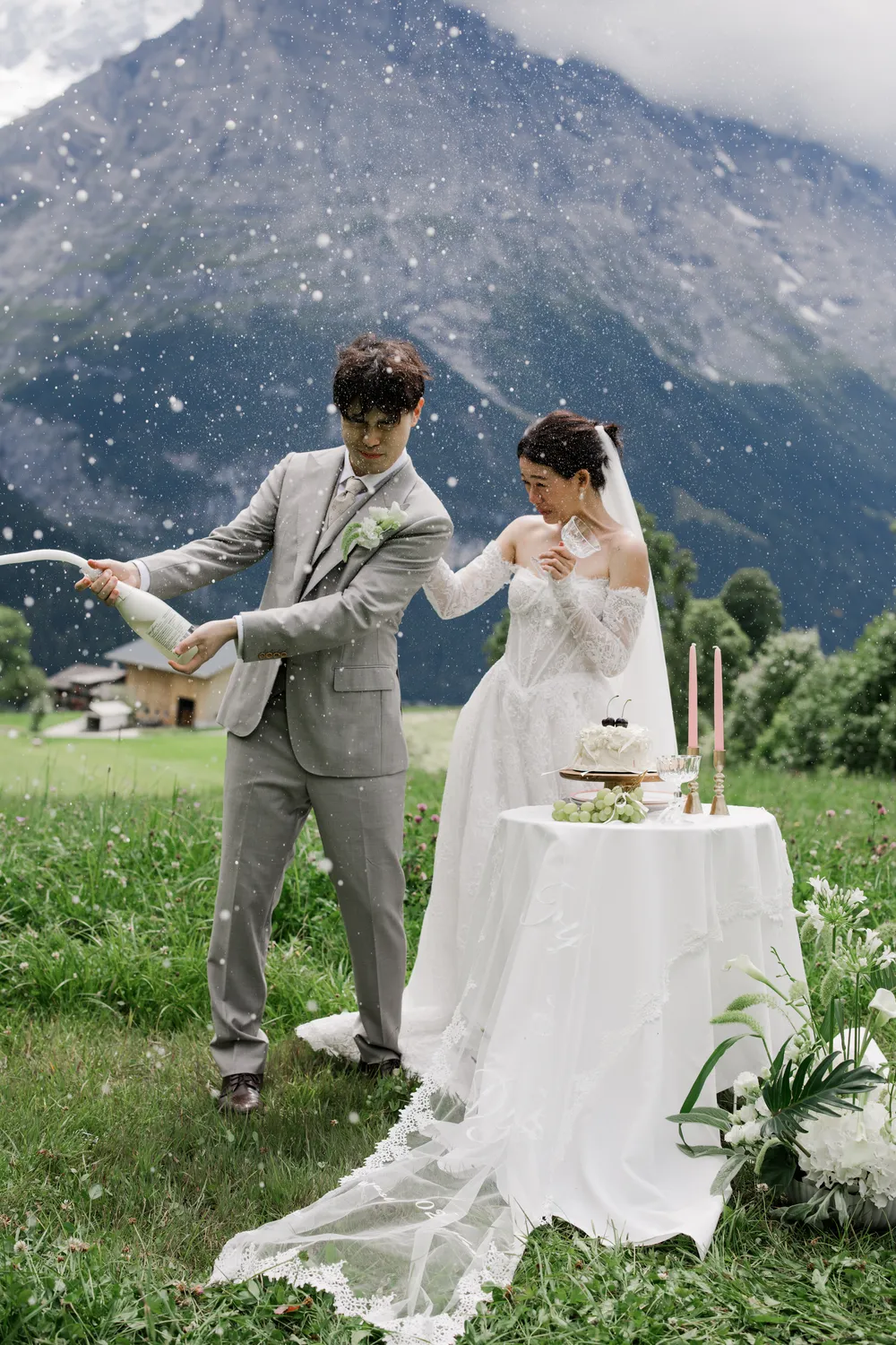 A playful, spontaneous champagne pop during an outdoor **Grindelwald wedding celebration**.