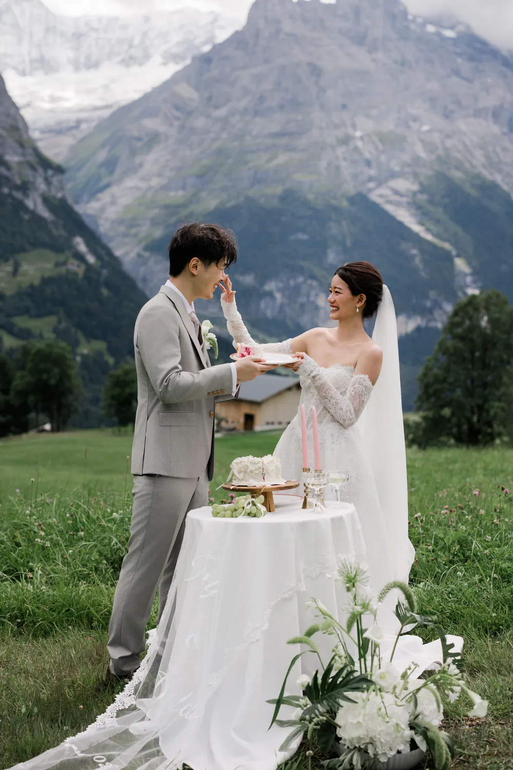 A cute, bespoke wedding cake featuring a tiny 'Best Day Ever' topper at a high-altitude **Swiss elopement**.